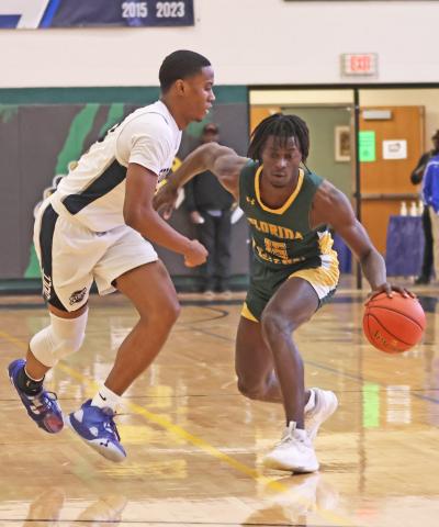 FGC guard Maurice Campbell dribbles while being defended by Davidson-Davie guard Jonathan Foust during the first round of the NJCAA tournament on Tuesday. (COURTESY OF NJCAA)