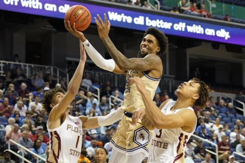 Georgia Tech forward Javon Franklin drives between Florida State guards Jalen Warley (1) and Cam Corhen (3) during an ACC tournament game on Tuesday in Greensboro, N.C. (CHUCK BARTON/Associated Press)