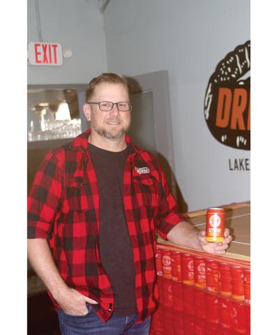 Chris Candler, co-owner of Halpatter Brewing Company, holds one of the cans of Seymour Finnegan’s, the brewery’s first cans set for distribution. (JAMIE WACHTER/Lake City Reporter)
