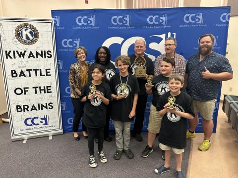 Fort White Elementary School won the 2023 Kiwanis Battle of the Brains on Thursday. Team members, in front, include Sarah Rafael (from left), Wyatt Chism,Tucker Ayers and Brayden Blalock. They are joined in back by Stephanie Lunde, Dr. Marilyn Gassett, Alan Gatzke, John Kasak, and James Carter, the president of Lake City Kiwanis Club. (COURTESY)