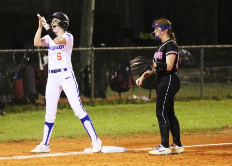 Branford third baseman Madyson Sikes celebrates in front of Fort White third baseman Hannah LeBleu after reaching third base safely on Monday night. (JORDAN KROEGER/Lake City Reporter)