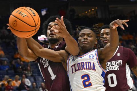 Mississippi State forward Tolu Smith and Florida guard Trey Bonham battle for the ball during Thursday's game of the SEC tournament in Nashville, Tenn. (JOHN AMIS/Associated Press)