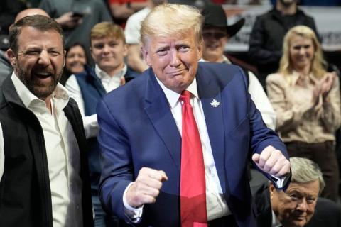 Former President Donald J. Trump gestures at the NCAA Wrestling Championships, Saturday, March 18, 2023, in Tulsa, Okla. (SUE OGROCKI/Associated Press)