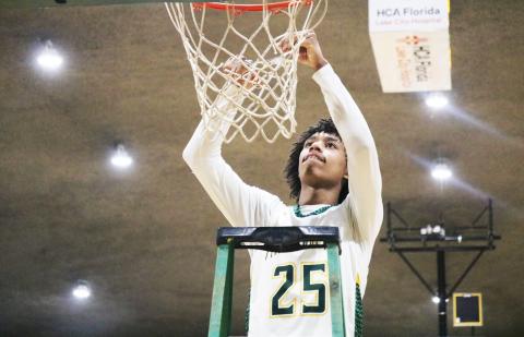 FGC guard Antewan Webber cuts down the net after the Timberwolves defeated Pitt CC to win the South Atlantic District B championship on March 11.  (JORDAN KROEGER/Lake City Reporter)