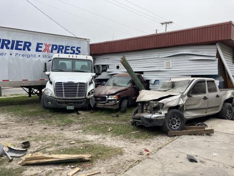 A semi truck and trailer crashed into vehicles at the Auto Unique repair shop Tuesday morning in Mayo, pushing them into the Mayo Laundromat. (COURTESY FLORIDA HIGHWAY PATROL)