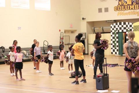Members of the Columbia High School color guard introduce girls to the activity during a clinic Saturday. (COURTESY)