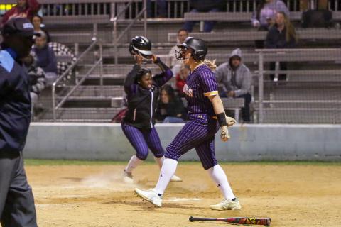 Columbia's McKenna O'Sullivan (left) and Zoryana Hughes (right) celebrate at home plate after Hughes scored the game-winning run to beat Baker County in extra innings on Monday night. (BRENT KUYKENDALL/Lake City Reporter)