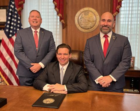 House bill sponsor Chuck Brannan (from left), Gov. Ron DeSantis and Senate bill sponsor Jay Collins pose at Monday’s bill signing event. (COURTESY)