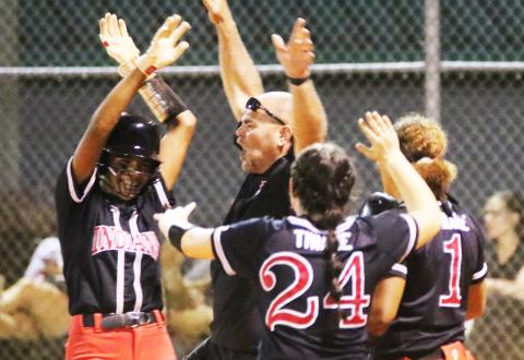 Fort White catcher Morgan (left) celebrates with coach Chad Padgett (middle) and pitcher Kadence Compton (24) after hitting a walk-off RBI single to defeat Baldwin on Thursday night. (JORDAN KROEGER/Lake City Reporter)