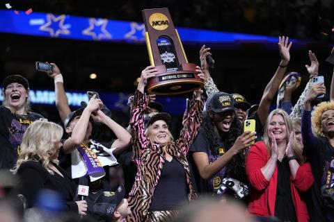 LSU head coach Kim Mulkey holds the winning trophy after the Tigers defeated Purdue in the national championship on Sunday in Dallas. (TONY GUTIERREZ/Associated Press)