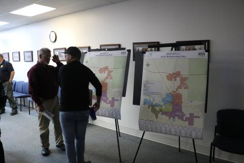 Lake City Assistant Police Chief Andy Miles (left) looks over the proposed redistricting maps with Joshua Garner after the Lake City Council’s workshop Tuesday. (MORGAN MCMULLEN/Lake City Reporter)