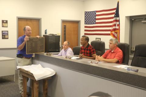 Will Rutherford with Clemons Rutherford & Associates presents the Lafayette County Commission with a plaque commemorating the Lafayette County Courthouse renovations. County Clerk Steve Land (second from left), Chairman Earnest Jones and Commissioner Lance Lamb look on. (MORGAN MCMULLEN/Lake City Reporter)