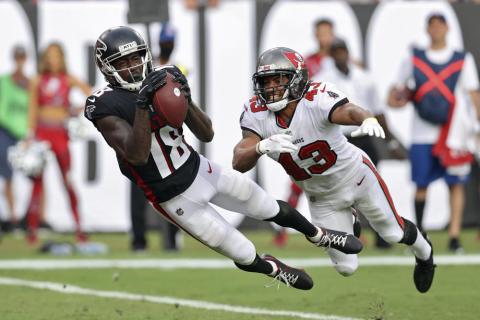 Former Atlanta Falcons wide receiver Calvin Ridley makes a diving touchdown reception in front of Tampa Bay Buccaneers defensive back Ross Cockrell on Sept. 19, 2021, in Tampa. (MARK LOMOGLIO/AP File)