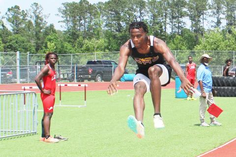 Columbia’s Seth Stockton leaps in the triple jump during the District 2-3A meet on Friday. (COURTESY)