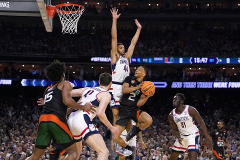 Miami guard Isaiah Wong (2) drives to the basket against Connecticut guard Andre Jackson Jr. (44) during the Final Four on Saturday in Houston. (DAVID J. PHILLIP/Associated Press)