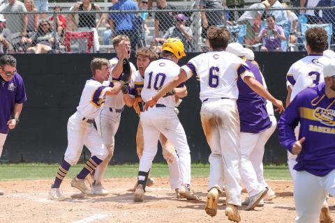 Columbia players swarm Josh Fernald at home plate after Fernald hit a walk-off grand slam against Lincoln on Saturday in the Region 1-5A semifinals. The Tigers won 8-4. (BRENT KUYKENDALL/Lake City Reporter)