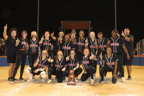Fort White celebrates with the District 6-1A championship trophy after defeating Branford 7-0 on Thursday night. (PAUL BUCHANAN/Special to the Reporter)