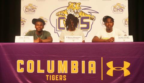 Columbia basketball players Isaac Broxey (from left), D’Maceo Sheppard and Ty’jahn Wright signed letters of intent to play at Florida Gateway College on Wednesday. (JORDAN KROEGER/Lake City Reporter)