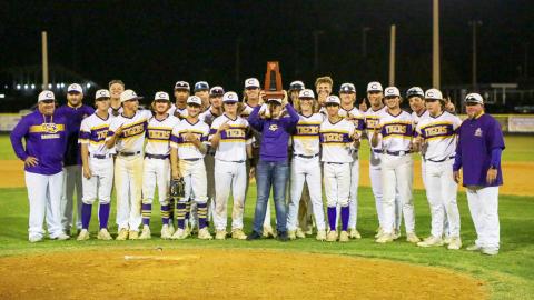 Columbia celebrates with the District 2-5A championship trophy after defeating Lincoln 9-0 on Wednesday night. (BRENT KUYKENDALL/Lake City Reporter)