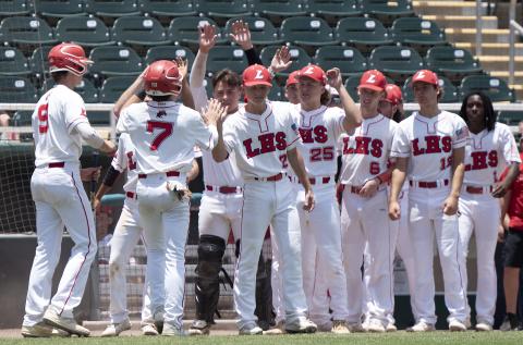 Lafayette’s Garrett Taylor (9) and Baylor Johnson (7) are greeted by teammates after scoring against Holmes County during the Class 1A state semifinals on Wednesday at Hammond Stadium in Fort Myers. (CHRIS TILLEY/Special to the Reporter)