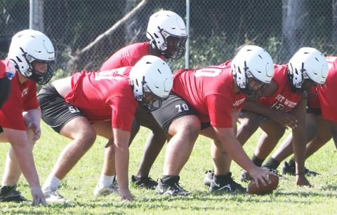 Fort White quarterback Jayden Jackson gets set to take a snap during practice on May 1. (MORGAN MCMULLEN/Lake City Reporter)