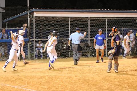 Deltona's Sophie Stempel, Christina Ortiz and Emily Donohue celebrate after scoring three runs while Columbia catcher Emily Delgado looks on during Thursday's Region 1-5A quarterfinal. (JORDAN KROEGER/Lake City Reporter)