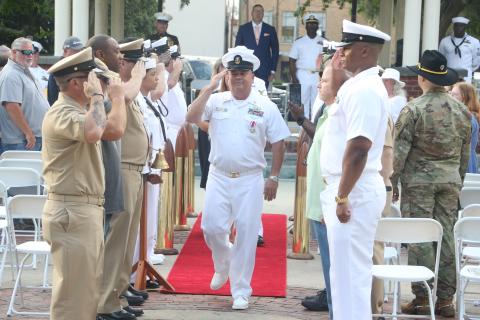 U.S. Navy Master Chief Damage Controlman Robert Ratliff salutes fellow service members as he “comes ashore” during his retirement ceremony Friday. (MORGAN MCMULLEN/Lake City Reporter)