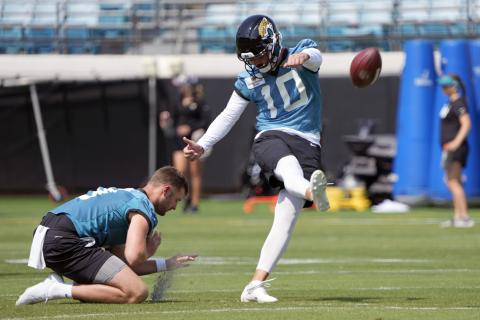 Jacksonville Jaguars kicker Brandon McManus (10) works on field goals as Logan Cooke holds during practice on Tuesday in Jacksonville. (JOHN RAOUX/Associated Press)
