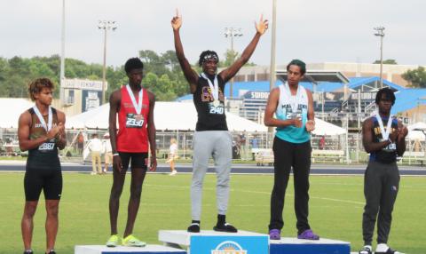 Columbia’s Seth Stockton celebrates on the podium after winning the class 3A state title in the triple jump on Friday. (COURTESY)