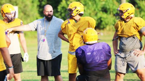 Columbia offensive line coach John Woodley works with the offensive line during Monday’s practice. (JORDAN KROEGER/Lake City Reporter)