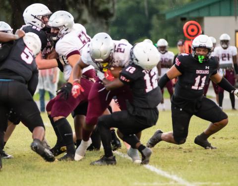Fort White defensive back Najeeb Smith tackles Madison County running back Jason McDaniel as linebacker Lecosta Byrd rushes in during Tuesday’s spring game. (CHRISTINA FEAGIN/Special to the Reporter)