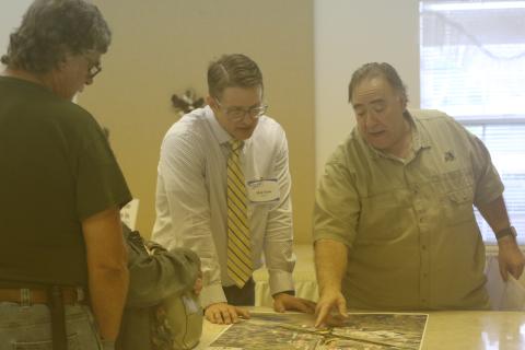 Tim Liguori (right) talks with Florida Department of Transporation’s Nick Hope about the state’s plans for the State Road 247 and County Road 240 intersection during an open house Thursday. (JAMIE WACHTER/Lake City Reporter)