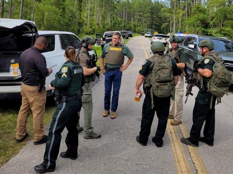 Columbia County Sheriff Mark Hunter (middle) and law enforcement officers stand near the scene of Monday's events on Mershon Street north of Lake City. (COURTESY CCSO)