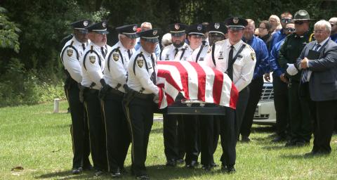 Former Jasper Police Chief Anthony ‘Tony’ Rickerson’s flag-draped casket is carried into the cemetery at Burnham Christian Church in Jennings by the honor guard Tuesday. (MORGAN MCMULLEN/Lake City Reporter)