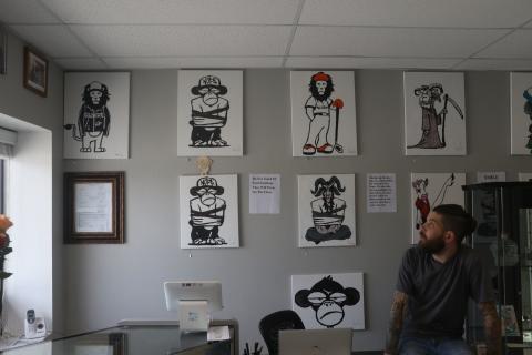 Meditating Monkey Art Emporium owner Gary Rife explains the concept behind the animal artwork Friday. (MORGAN MCMULLEN/Lake City Reporter)