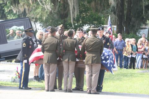 The casket of U.S. Army Cpl. Alton Christie is carried to his final resting place at Evergreen Cemetery in Jasper on Saturday morning. Hundreds of friends, family members and supporters gathered for Christie’s funeral. (MORGAN MCMULLEN/Lake City Reporter)