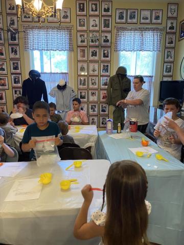 Landon Ream, left, is among the children that learned how to make ice cream in a bag Thursday at the Lake City-Columbia County Historical Museum. (COURTESY)