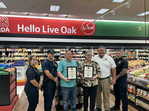 Ana Gienger and Stephan Little were issued life-saving awards from Suwannee County Fire Chief Eddie Hand and paramedics after performing CPR on a man suffering cardiac arrest at Winn-Dixie on June 14. (COURTESY SUWANNEE COUNTY FIRE RESCUE)