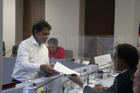 Nick Patel hands out information to the Lake City Council at Monday’s meeting about the proposed Circle K expansion. (MORGAN MCMULLEN/Lake City Reporter)