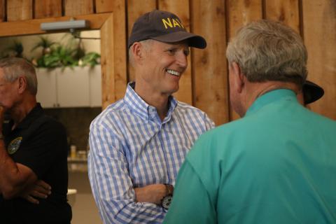 Sen. Rick Scott smiles as he talks with Hamilton County Sheriff Harrell Reid during a visit to the Nutrien Conference Center in White Springs on Thursday. (JAMIE WACHTER/Lake City Reporter)