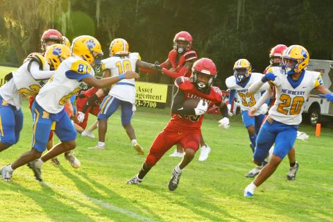 Lafayette’s Maurice Vought runs through the hole against Newberry during Friday night’s Preseason Classic. (ROB WOLFE/Special to the Reporter)