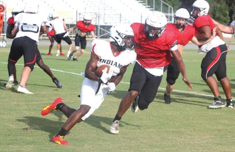 Fort White running back Dakota Fisher takes a carry up the field during Friday’s scrimmage. (MORGAN MCMULLEN/Lake City Reporter)