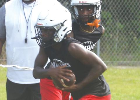 Fort White receiver Najeeb Smith takes a handoff from quarterback Jayden Jackson during practice on July 31. (MORGAN MCMULLEN/Lake City Reporter)
