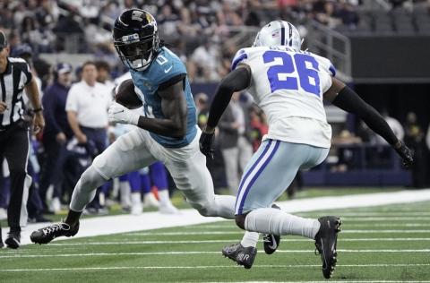 Jacksonville Jaguars wide receiver Calvin Ridley carries the ball against Dallas Cowboys cornerback DaRon Bland on Saturday in Arlington, Texas. (SAM HODDE/Associated Press)