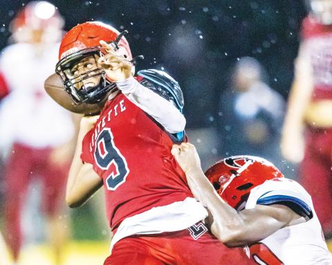 Lafayette quarterback Tywan Williamson throws a pass under pressure against Hamilton County last season. (FILE)