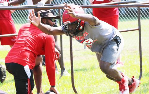 Lafayette defensive end Amarie Fleming performs a drill with head coach Marcus Edwards during Tuesday’s practice. (JAMIE WACHTER/Lake City Reporter)