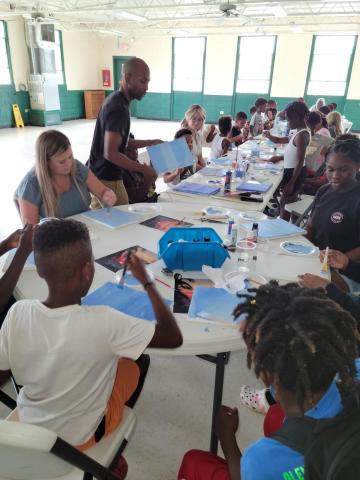 Children receive a painting lesson from Pedro Jermaine, a professional artist from Live Oak, during a Hands of Change event at Richardson Community Center. (COURTESY)