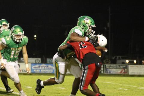 Suwannee defensive lineman JaDarius Cherry sacks Munroe quarterback Demaris Bunion on Friday night as Bunion’s helmet comes off. (JAMIE WACHTER/Lake City Reporter)