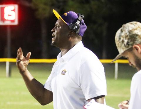 Columbia head coach Brian Allen signals a play into his team against Buchholz on Aug. 26. (JORDAN KROEGER/Lake City Reporter)