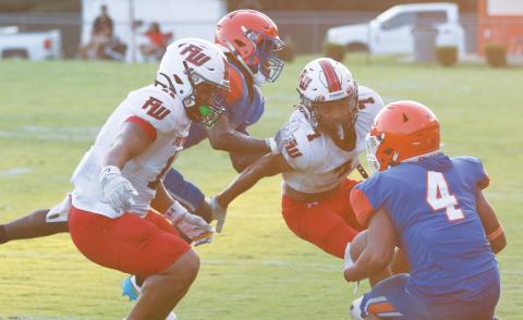Fort White linebacker Lecosta Byrd (left) and defensive back Tafari Moe close in for a tackle against Jefferson County on Monday night. (MORGAN MCMULLEN/Lake City Reporter)